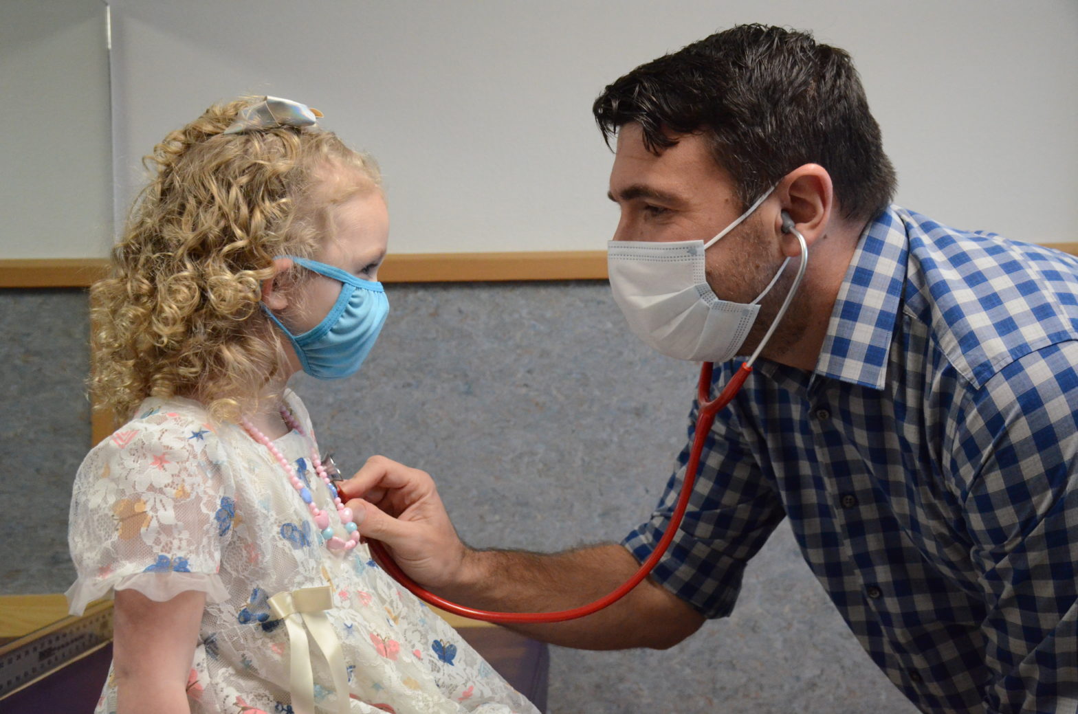 Physician Assistant Brian Mills checks his patient's heartbeat